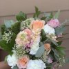 Bouquet of peach, pink, and white flowers with greenery
