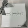 White chocolate gift box with a gray ribbon bow