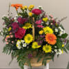 A lively burst of spring in a woven basket-this flower arrangement is
