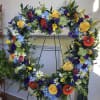 Large floral wreath on an easel with multicolored flowers