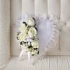 Heart-shaped lace wreath with white roses and ribbon