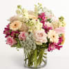 Pink and cream mixed bouquet in a clear glass vase