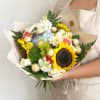 Handheld bouquet with a sunflower, roses, hydrangea, and chocolates