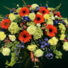 Large bouquet of orange gerbera daisies, pale roses, and blue flowers