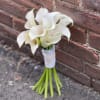 Small bouquet of white calla lilies tied with white ribbon