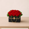 A chic handbag-style flower arrangement designed in a sleek black keepsake container