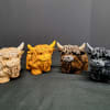 Playful collectible accent pieces shaped like Highland cows bring a touch of