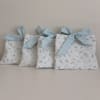 Delicate hand-quilted fabric pouche make a charming alternative gift presentation for a