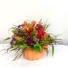 This beautiful fall arrangement features spray roses, mums and fall grasses and