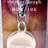 Keychain with a round beige charm on a printed card