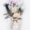 Bouquet of white dried flowers with black foliage and a cream ribbon