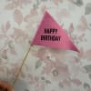 Pink felt birthday pennant on a wooden stick against a floral background