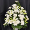 White lilies and chrysanthemums arranged in a white vase