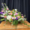 Large mixed bouquet in a gold vase with pink, white, and purple flowers