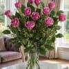 Pink roses arranged in a clear glass vase