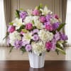 Pink and white floral arrangement in a white vase