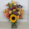 Mixed bouquet with a sunflower in a clear glass vase