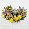 Colorful floral arrangement with a silver urn centerpiece
