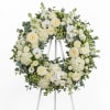 White floral wreath on a standing easel