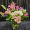 A lovely vase of pink lilies, white hydrangea, alstromeria and tulips.
Colors may
