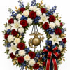 Circular wreath of red, white, and blue flowers with a patriotic emblem and ribbon
