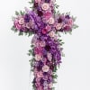 Purple and pink floral cross on a white stand