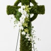 Moss-covered standing cross with white and green orchids