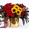 Dense clusters of red roses meet bright yellow sunflowers in a striking