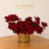 Red roses arranged in a gold textured vase on a wooden table