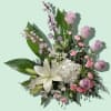 Lavender roses, white lilies, and white hydrangea in a mixed bouquet