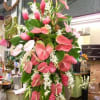 Tall tropical arrangement with pink anthuriums and white flowers