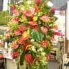 Tall tropical flower arrangement with red anthuriums and bird of paradise