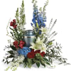 Sympathy urn arrangement with red, white, and blue flowers