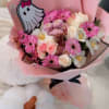Pink bouquet with roses, daisies, and white flowers in pink wrap