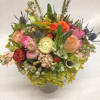 Mixed bouquet in a gray vase with pink, orange, yellow, and green blooms