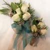 White rose bouquet with blue ribbon and matching boutonniere