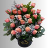 Pink roses arranged in a black vase with white filler flowers