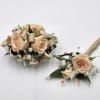 A boutonniere and wrist corsage set featuring peach spray roses, peach ribbon