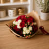 Bouquet of red and white roses wrapped in brown paper