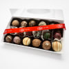Box of assorted chocolate truffles with a red ribbon