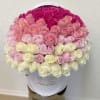 Large ombre arrangement of pink and white roses tightly packed in a white hat box