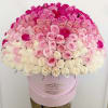 Large dome of white and pink roses arranged in a round pale pink hat box