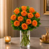 Orange roses arranged in a clear glass vase