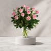Pink roses arranged in a clear glass vase