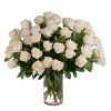 Large arrangement of white roses in a clear glass vase