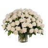 Large arrangement of white roses in a clear glass vase