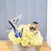 Cream rose arrangement in a round box with a teddy bear and graduation flag