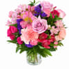 Pink and purple mixed bouquet in a clear glass vase