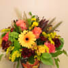 a beautiful fall motif arranged in a seasonal scene vessel 