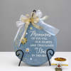 Blue memorial plaque with gold ribbon and star accents on a stand
